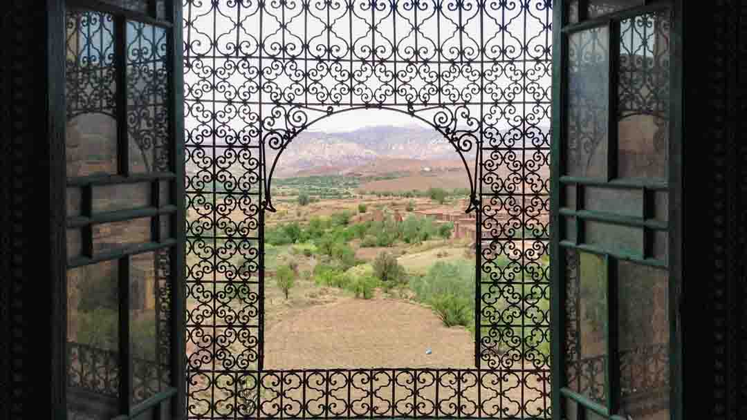 Moroccan style window with view of mountains.