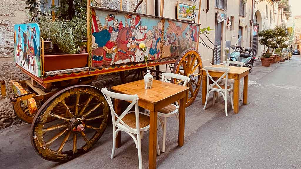 cafe in Sicily with colorful painted wagon